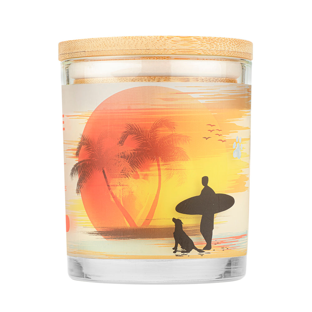 Beach Day Pet House Candle with a sunset design featuring a surfer and dog on a beach