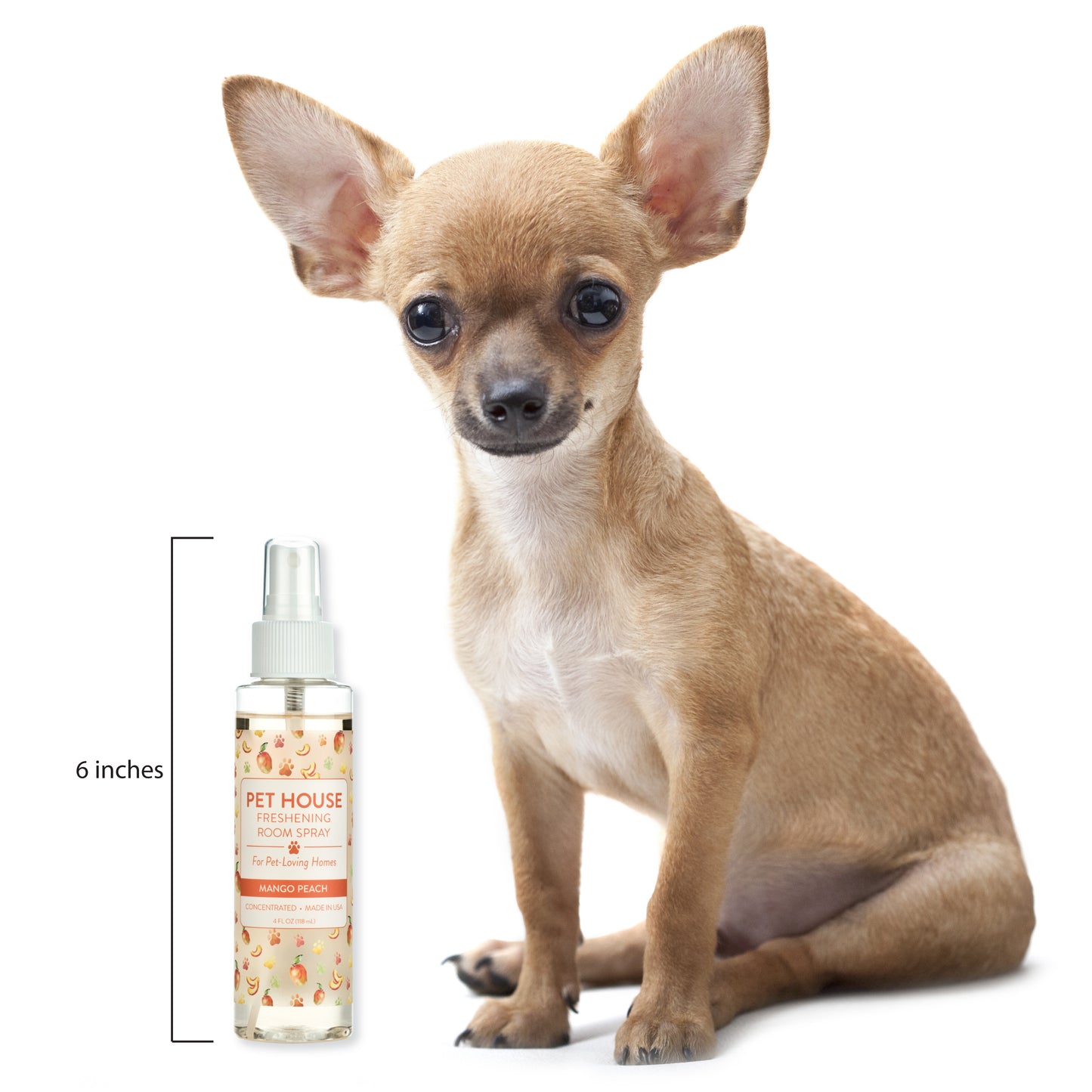 Small dog sitting next to a bottle of Pet House Naturals body spray on a white background